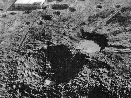 The 70 ft deep and 130 ft diameter crater which Grand Slam created in the New Forest on 13 March 1945 - with the target building in the background (Crown Copyright)
