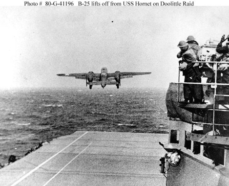 An Army Air Force B-25B bomber takes off from USS Hornet (CV 8) at the start of the raid, April 18, 1942. Note men watching from the signal lamp platform at right. (Official U.S. Navy Photograph, now in the collections of the U.S. National Archives – Courtesy of the NHHC Photo archives)