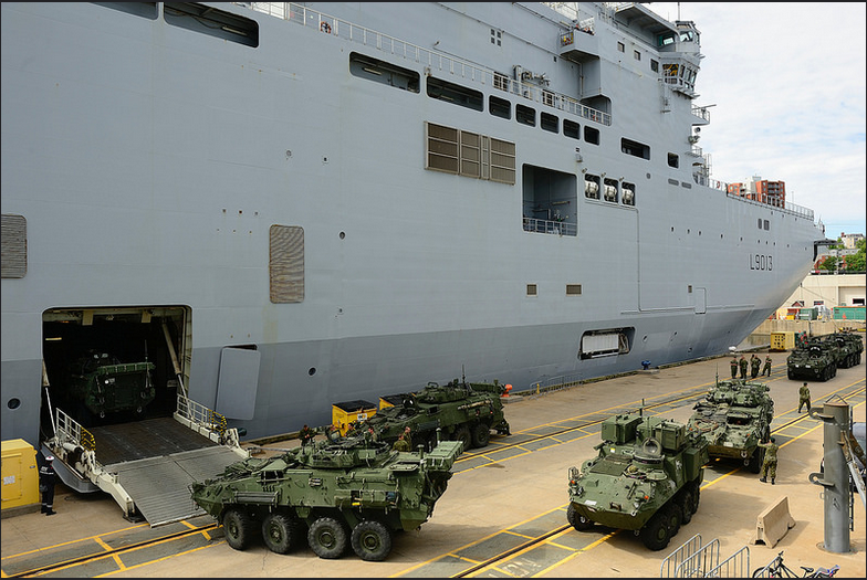 Members of the 1st Battalion, Royal 22e Regiment load light armored vehicles onboard the French Navy amphibious ship Mistral as part of Exercise LION MISTRAL 2014 in Halifax, Nova Scotia, June 17, 2014. Photo: MCpl Patrick Blanchard, Canadian Forces Combat Camera IS2014-3030-06