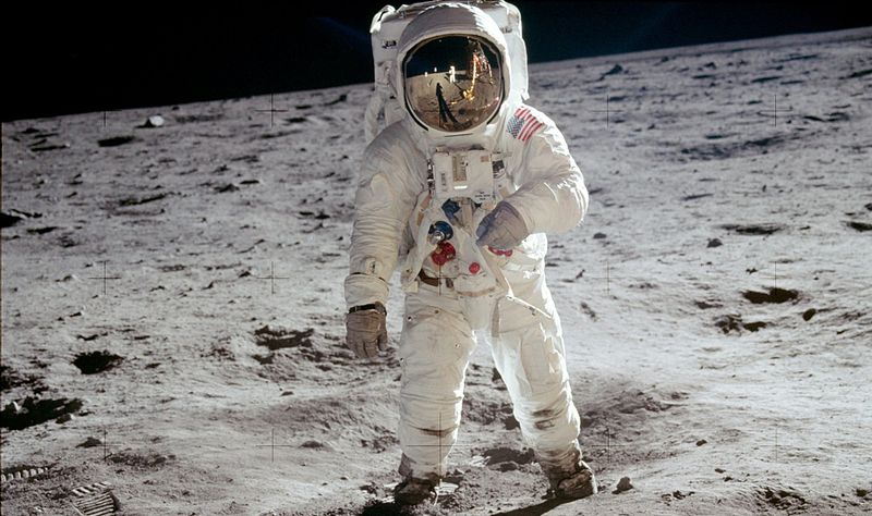 Astronaut Buzz Aldrin, lunar module pilot, stands on the surface of the moon near the leg of the lunar module, Eagle, during the Apollo 11 moonwalk. Astronaut Neil Armstrong, mission commander, took this photograph with a 70mm lunar surface camera. While Armstrong and Aldrin descended in the lunar module to explore the Sea of Tranquility, astronaut Michael Collins, command module pilot, remained in lunar orbit with the Command and Service Module, Columbia. *This is the actual photograph as exposed on the moon by Armstrong. He held the camera slightly rotated so that the camera frame did not include the top of Aldrin's portable life support system ("backpack"). A communications antenna mounted on top of the backpack is also cut off in this picture. When the image was released to the public, it was rotated clockwise to restore the astronaut to vertical for a more harmonious composition, and a black area was added above his head to recreate the missing black lunar "sky". The edited version is the one most commonly reproduced and known to the public, but the original version, above, is the authentic exposure.